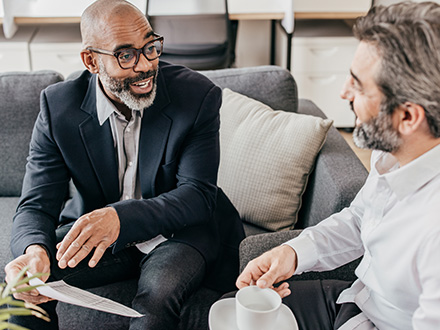 two men talking in an office